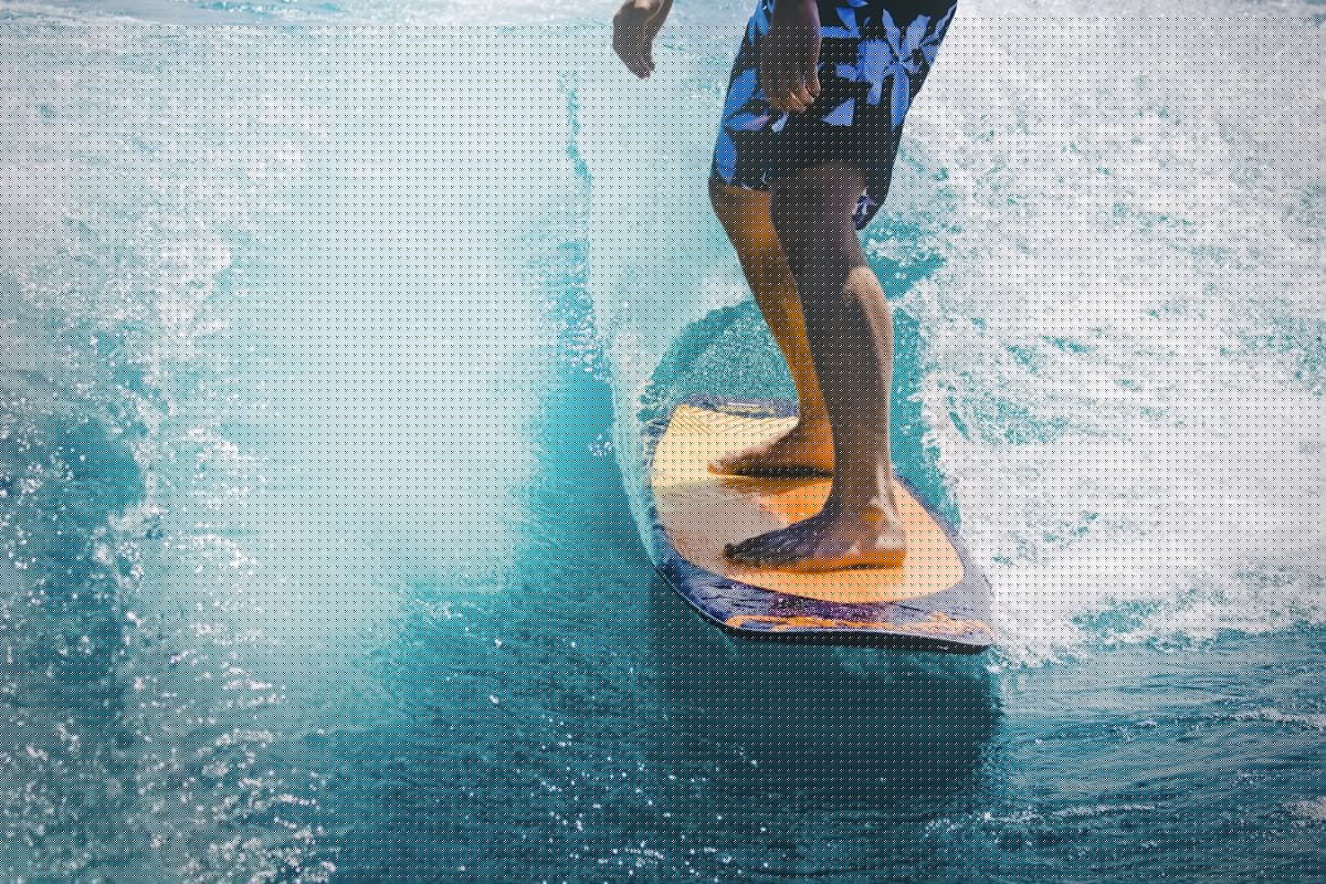Surfer riding a wave on a surfboard